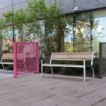 970 backed benches and Flexx panels in front of building with trees