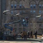 Construction workers suspending two circles in the air