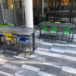 Foro bar height stools powdercoated green, yellow and blue with ancora table