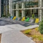 Yellow, Green and Blue patio seating outside glass building