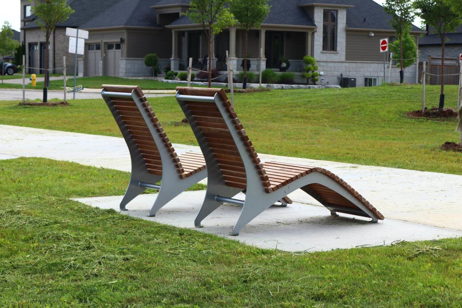 Two wood and metal chairs facing away from the camera