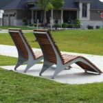 Two wood and metal chairs facing away from the camera