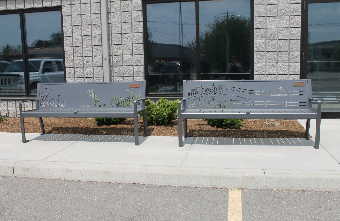 Two metal benches with designs carved in 