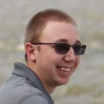 Jeremy-Headshot closeup headshot of young man smiling and wearing sunglasses