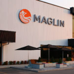 Maglin Logo on Building with patio below
