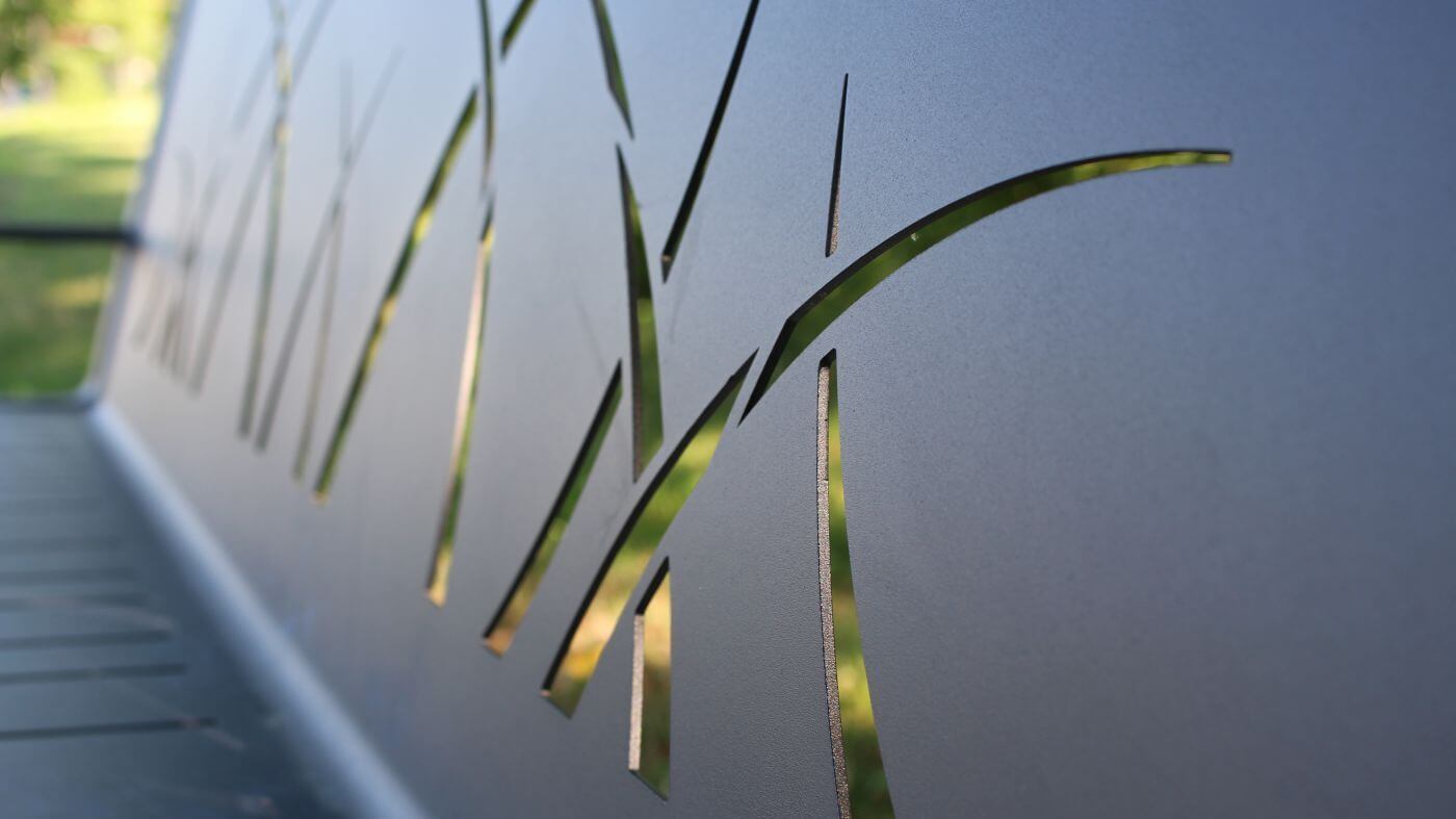 Close up of metal 970 bench with grass pattern