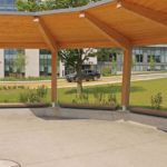 Straight Ogden Wall-Mount benches underneath sun shade