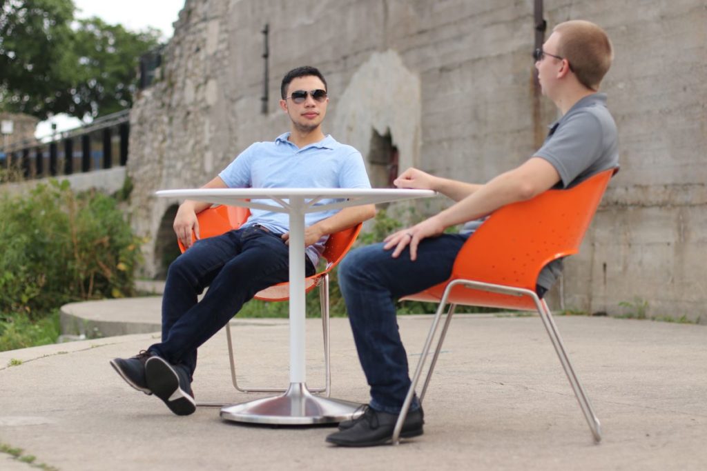 Shane and Jeremy Sitting in Orange Battery Chairs