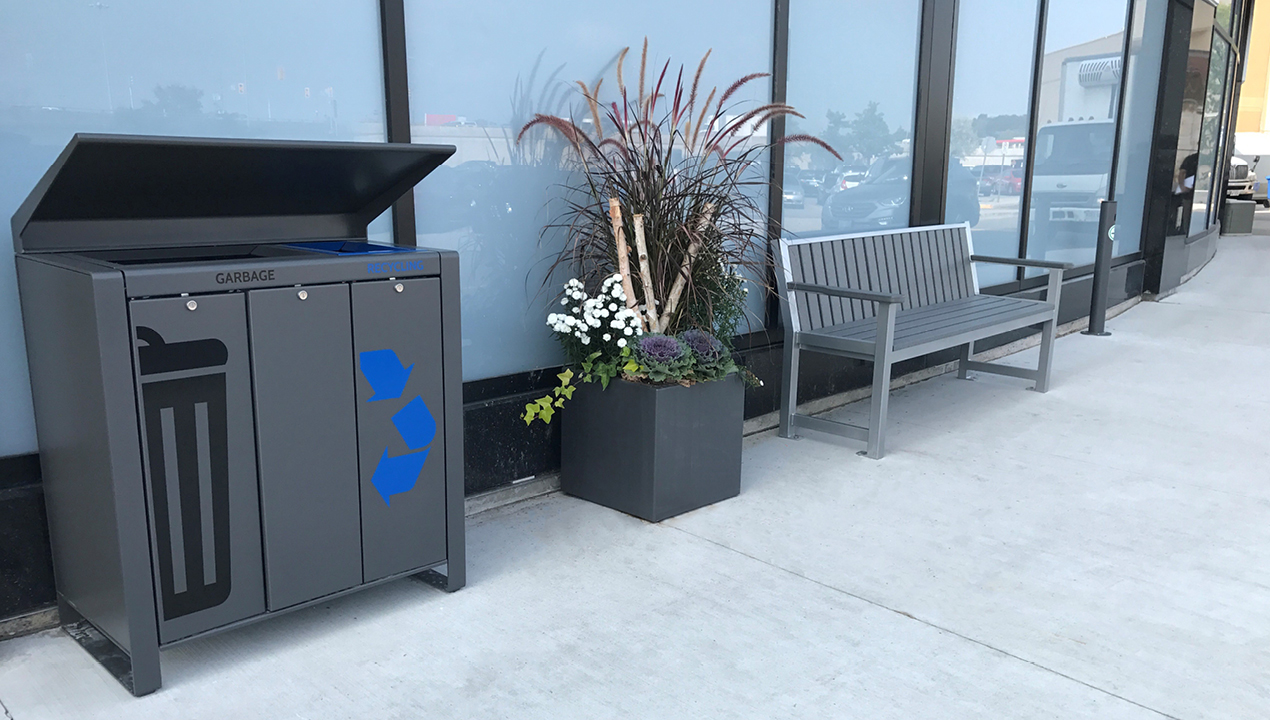 Garbage Unit, Planter and Backed Bench with Arms outside Building