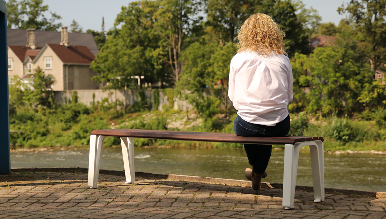 Woman on bench looking at River