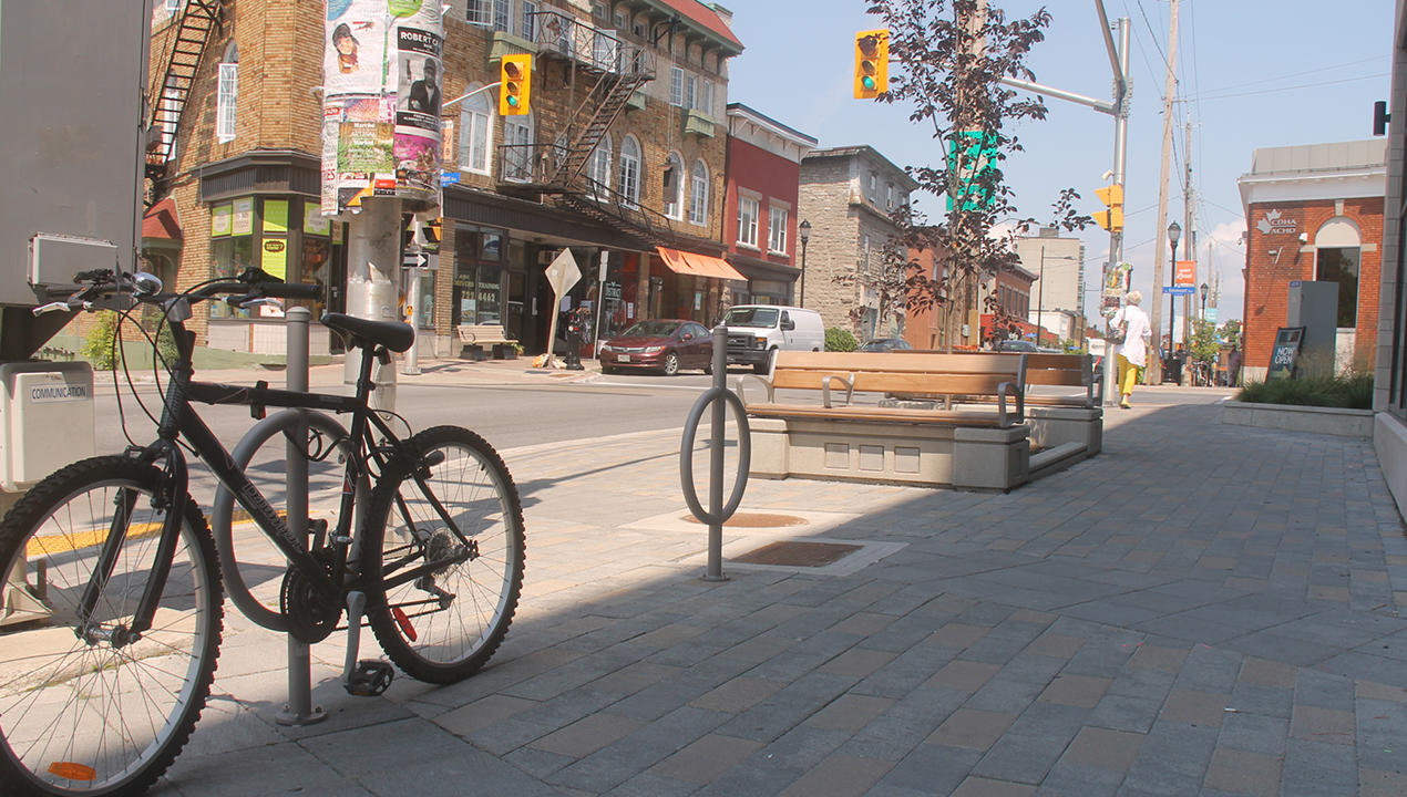 Silver Bike Racks with surface mounts on Downtown Streets