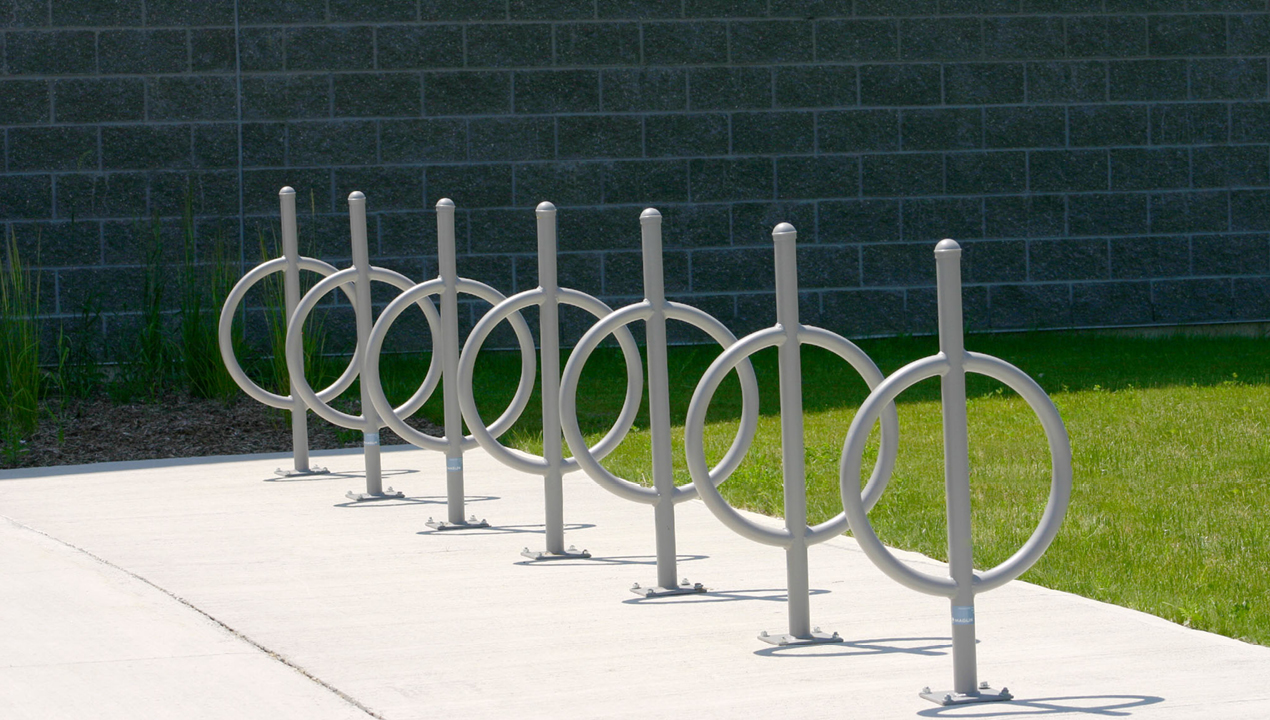 Seven Silver Bike Racks with Surface Mounts