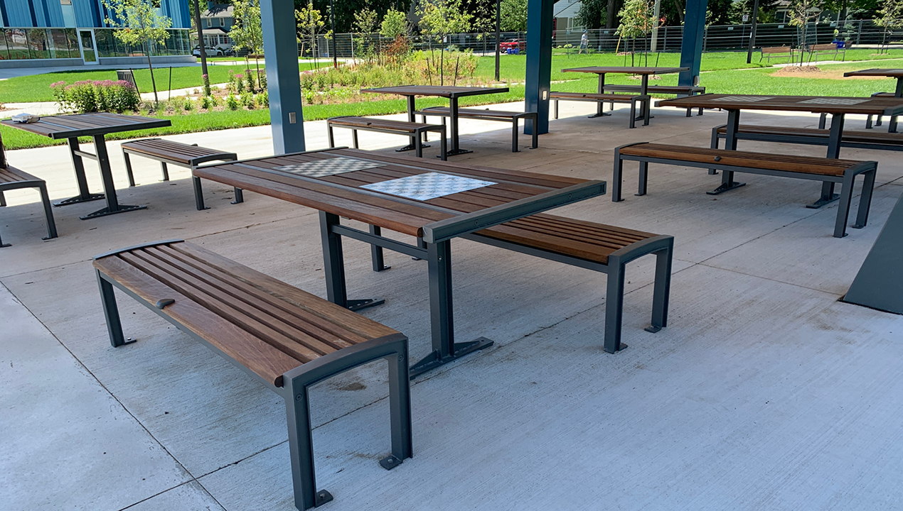 Multiple Table and Benches Under Pavillion Outside