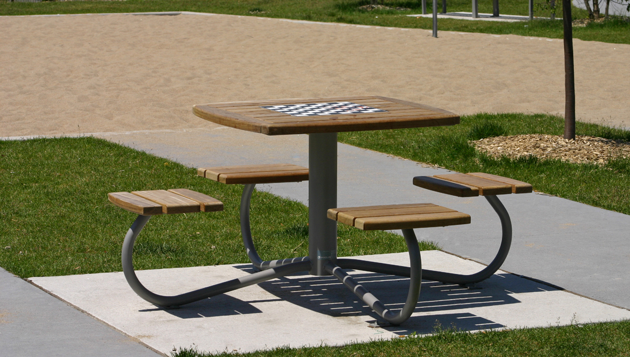 Table with Attached Individual Seating, with a chess board on top at a park