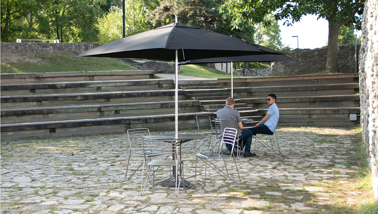Umbrella, table and chairs outside