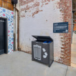 Lexicon trash and recycling unit against rustic brick wall
