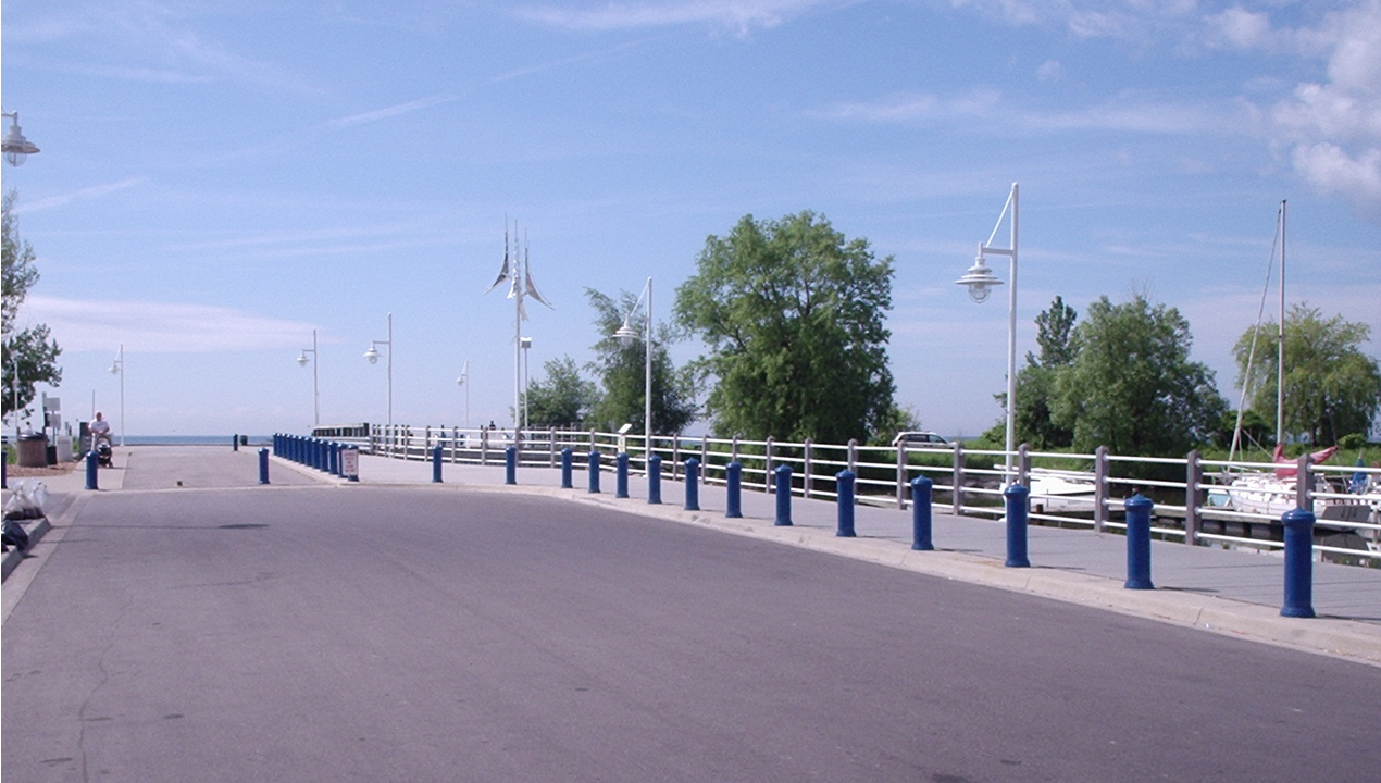 Blue sky and open road with blue bollards