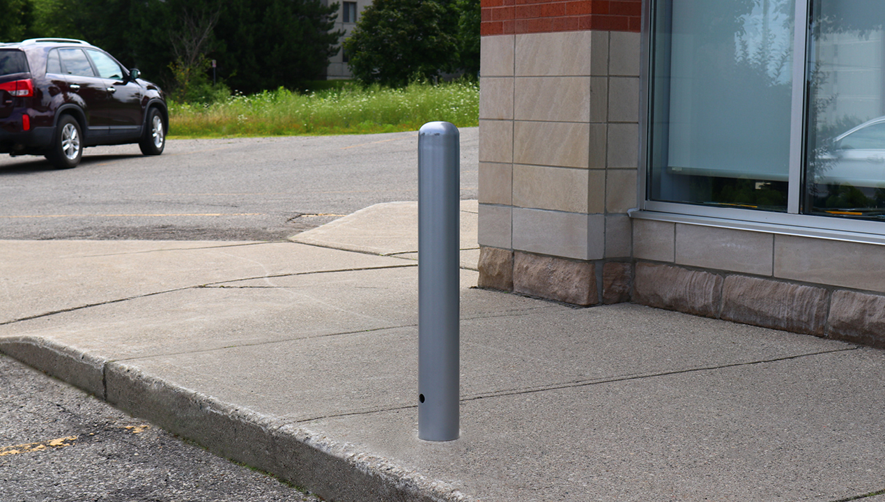 500 series bollard on side walk with vehicle in background