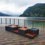 Bronze Pixel blocks with wood seats overlook a lake and mountains