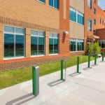 MUG Bike Racks painted gloss green and gunmetal in front of school building