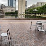 Maglin silver Foro tables and chairs before a large reflecting pool at Christian Science Plaza in Boston
