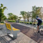 L-Series benches along a walkway with cyclist