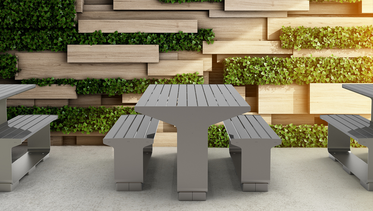 L-Series Tables and Seating next to green planter wall