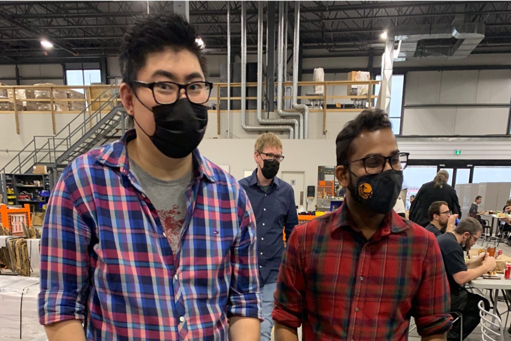 Chung-Vidu Chung and Vidu wearing plaid shirts at the office