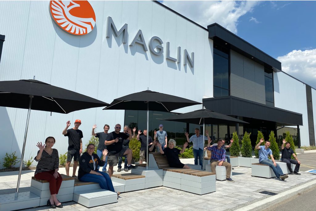 Maglin-wave Maglin team waving outside the head office on a sunny day