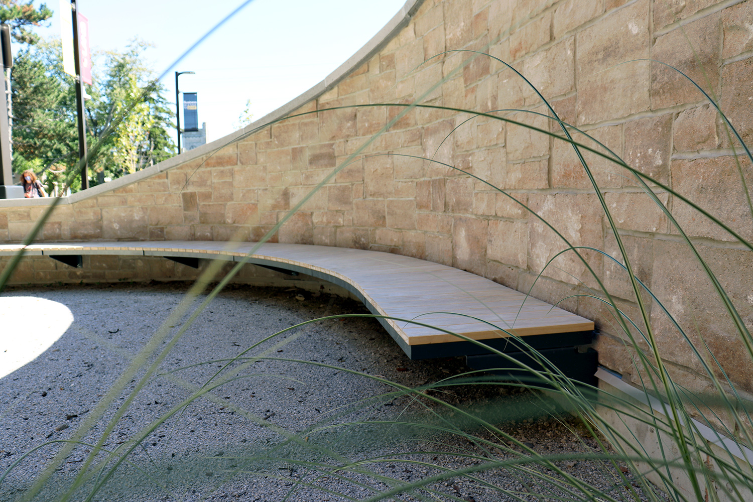 Curved Ogden Cantilever mounted Bench with custom wood at Lang Plaza