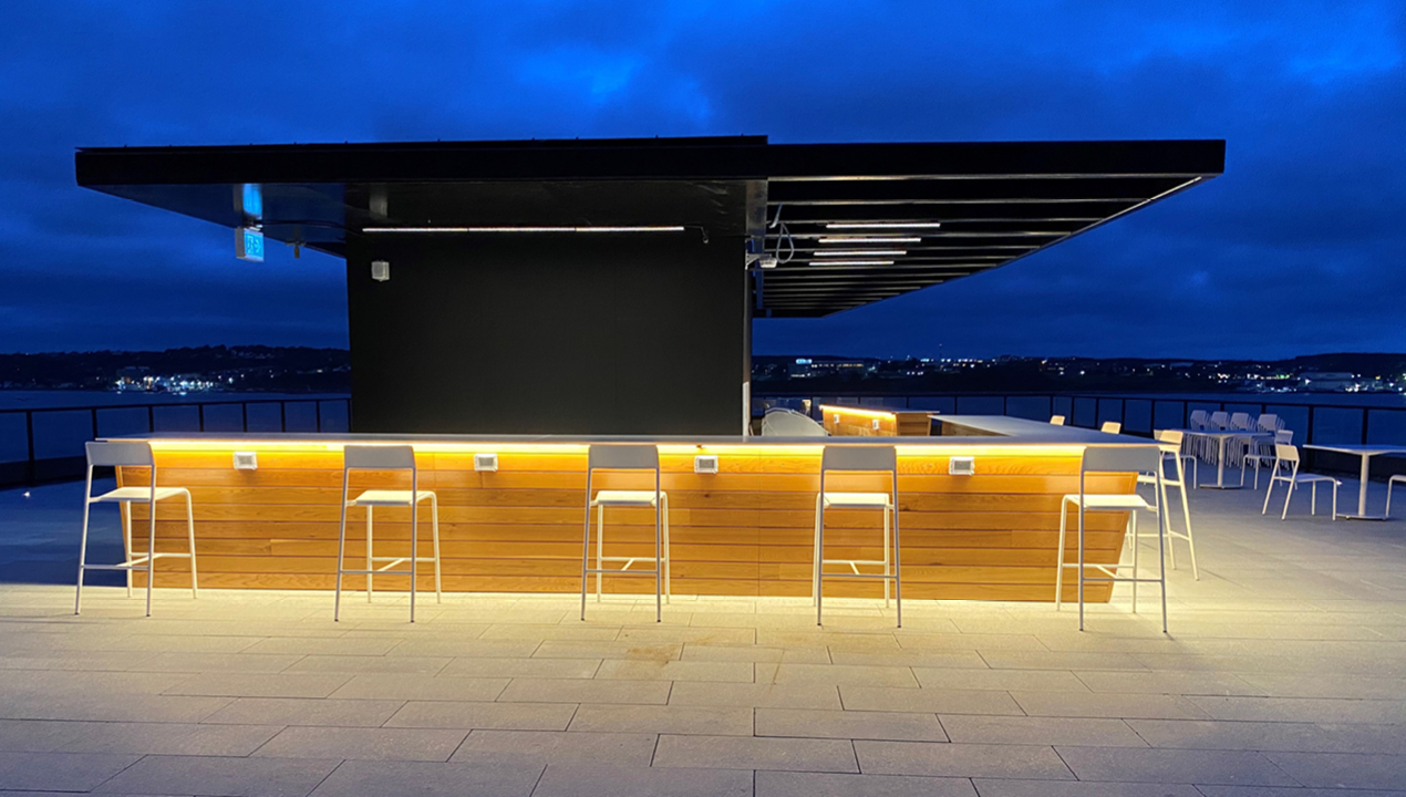 Foro Bar Height Stools powdercoated white next to bar on roof top patio