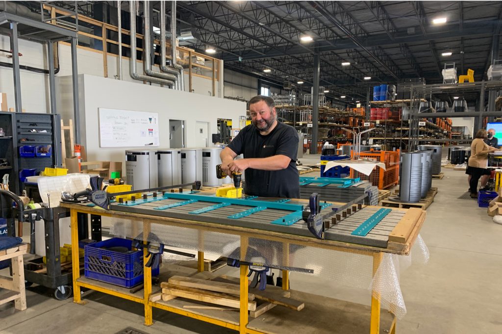 plant-worker Man assembling cluster seating table in Maglin plant