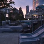 The Battery Playscape at twilight, showing the granite slides and custom cloud canopies