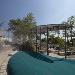 Children play in a mist feature at the Battery Playscape in New York City.