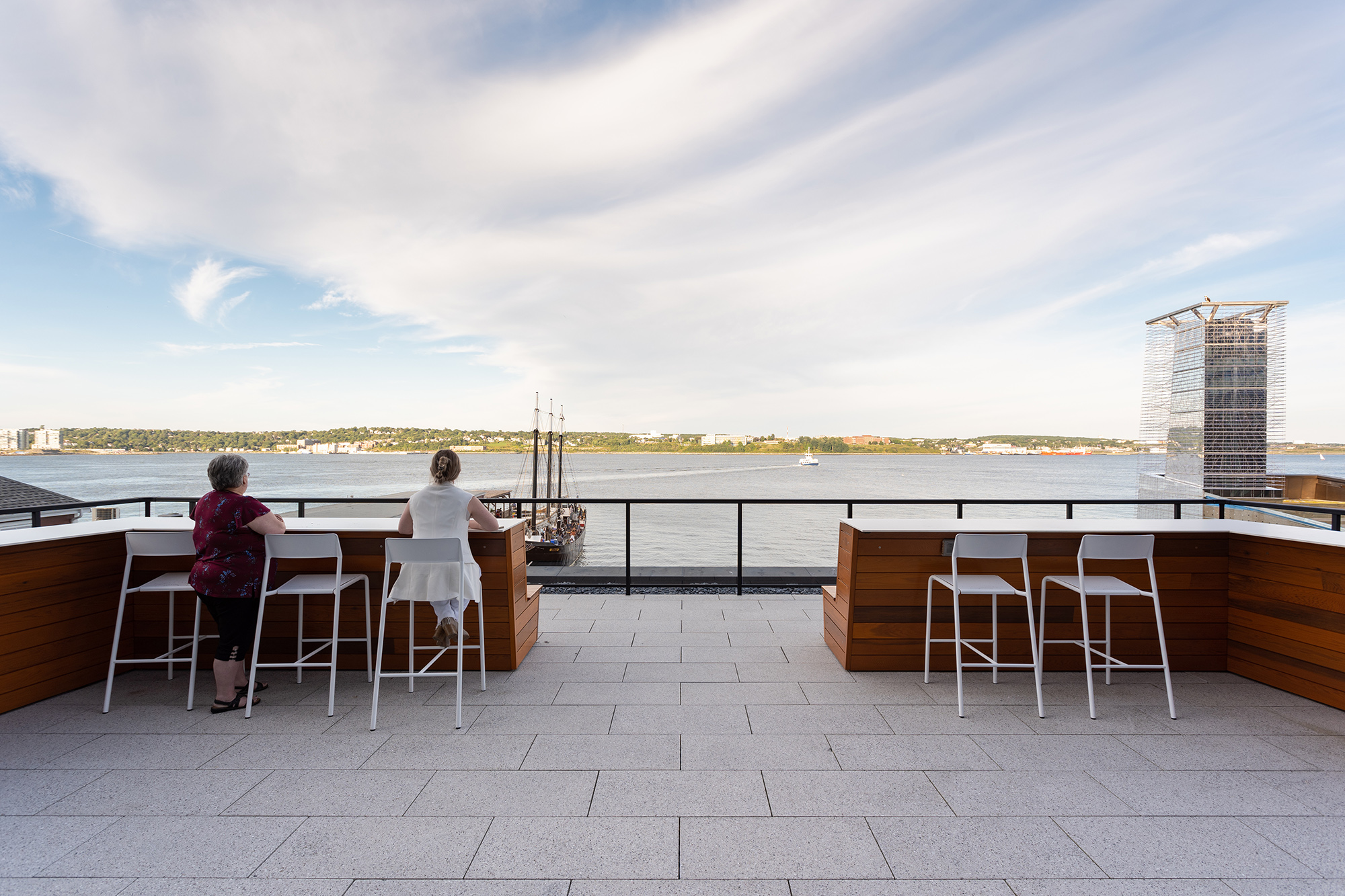 Foro-stools_stewart-mckelvey_01 Two employees look out on the harbor from Foro stools on the Stewart McKelvey rooftop terrace