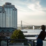 An employee looks out toward a bridge from the Stewart McKelvey rooftop terrace