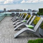 720 Lounges are lined up with 1050 short benches as side tables looking out from the roof deck of Viridian Apartments.