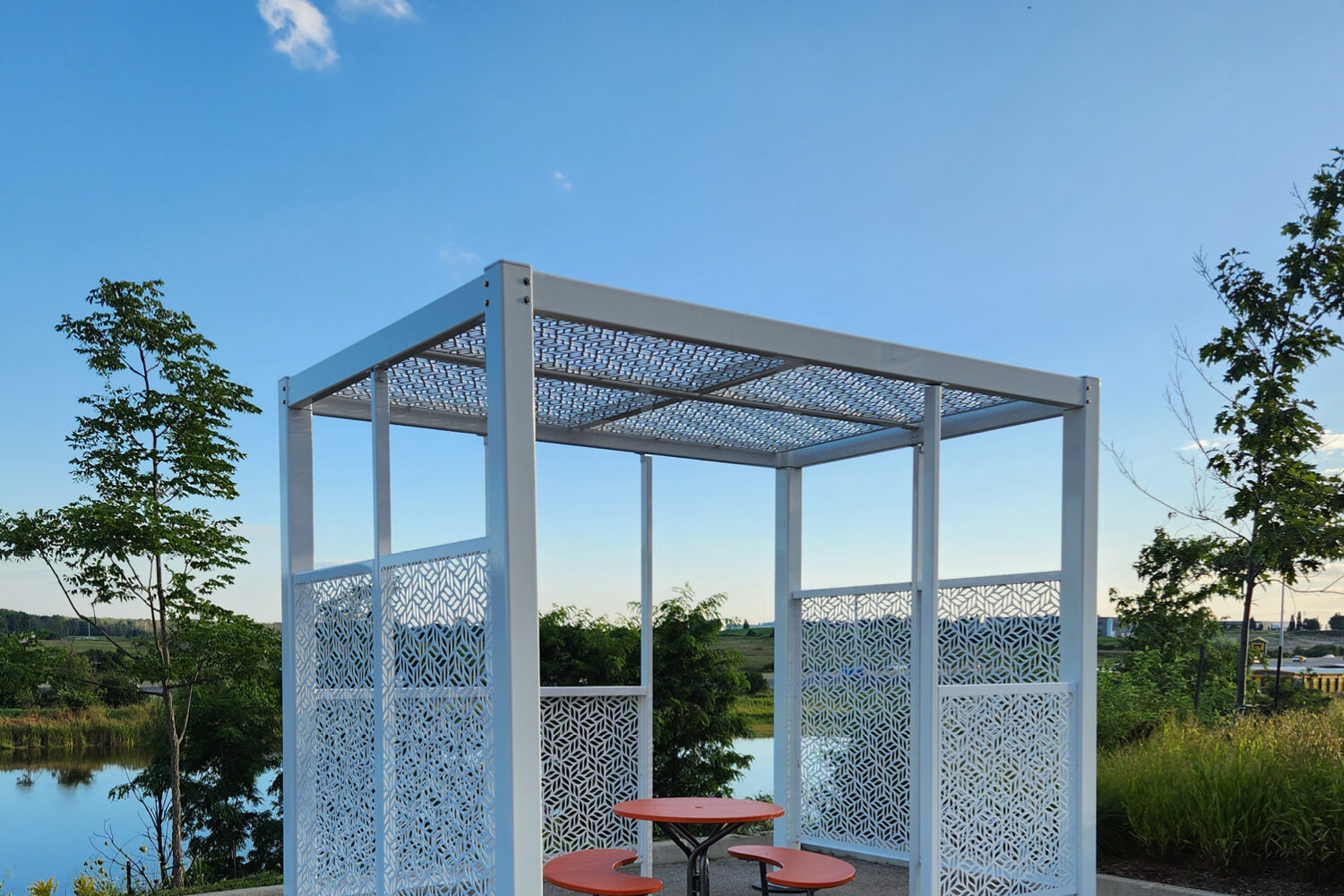 Maglin Head Office with Fava Tables and new Shade Structure with sky and pond in background