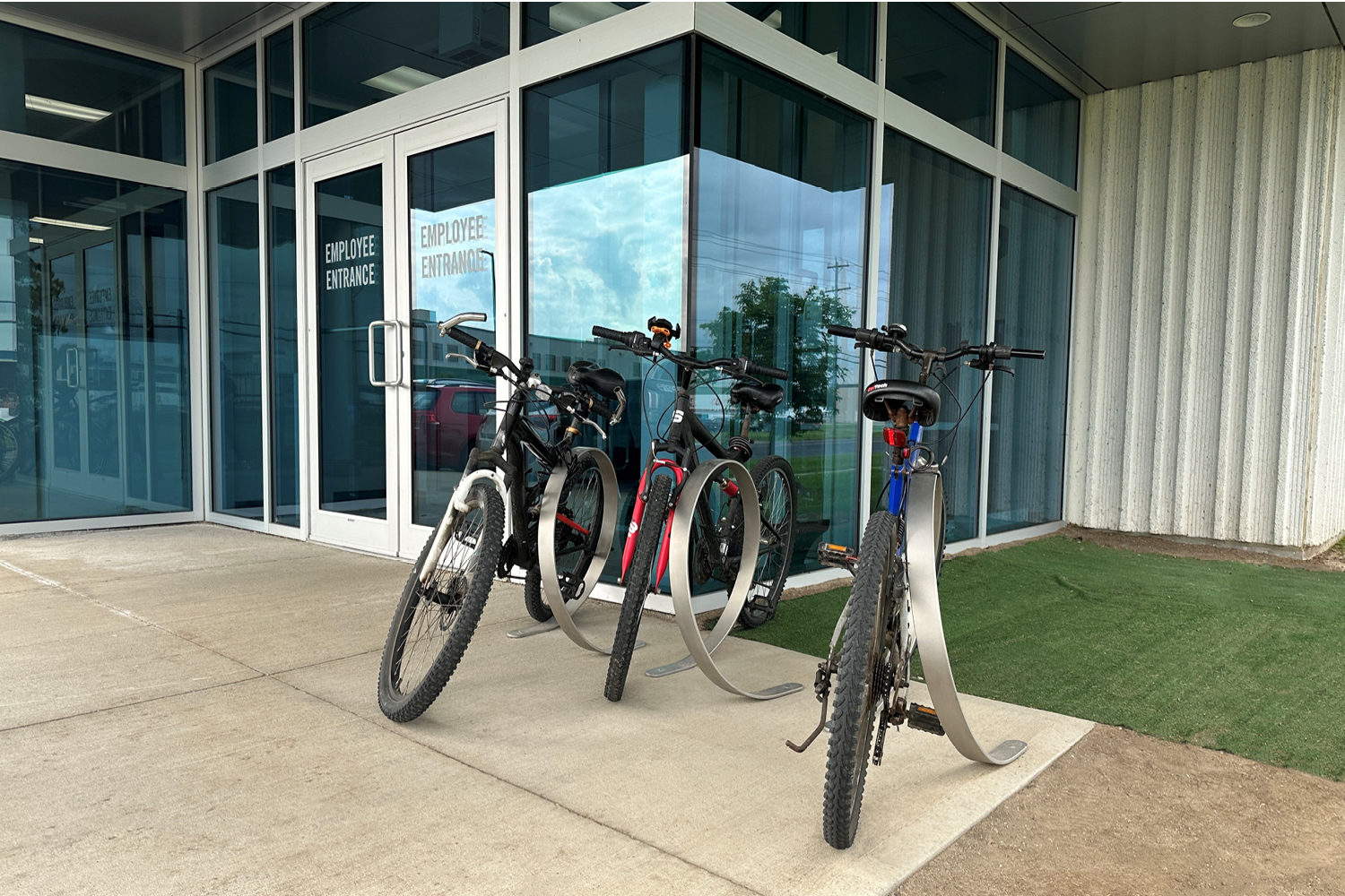 Orbit Bike Racks with bikes locked in front of glass entrance
