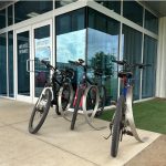 Orbit Bike Racks with bikes locked in front of glass entrance