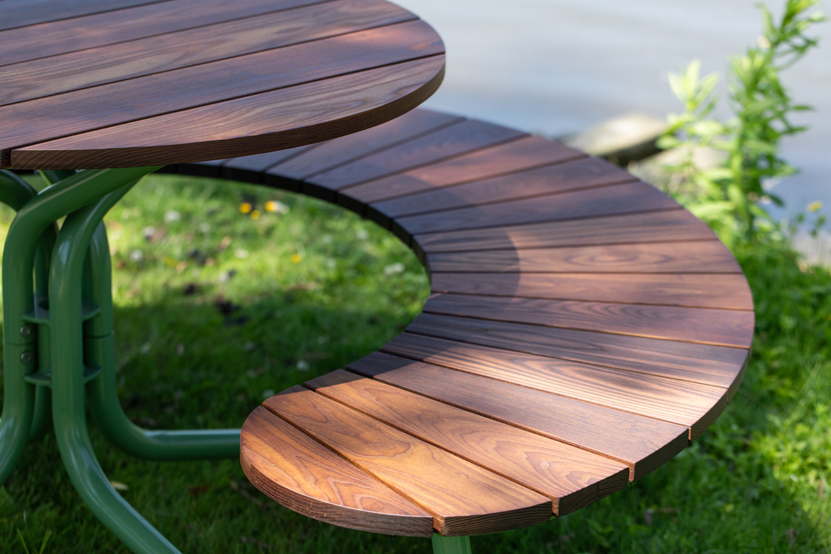 Close up of FAVA Cluster seating picnic table next to the water's edge in Stratford Ontario.