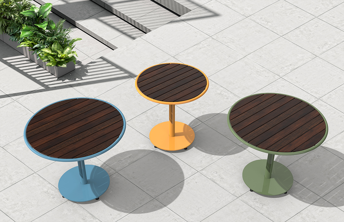 Top-down view of three Foro tables with thermally modified ash tops. Left to Right, blue, yellow and green. Placed on a light grey concrete patio.