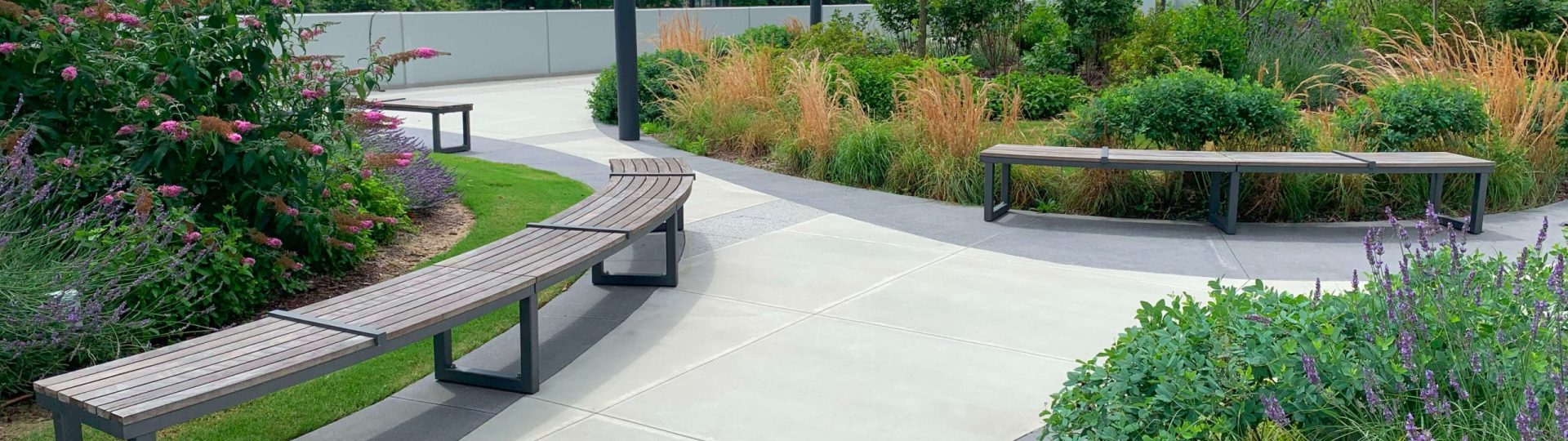 maglin-ogden-outdoors Backless Ogden benches sitting along pathway surrounded by greenery