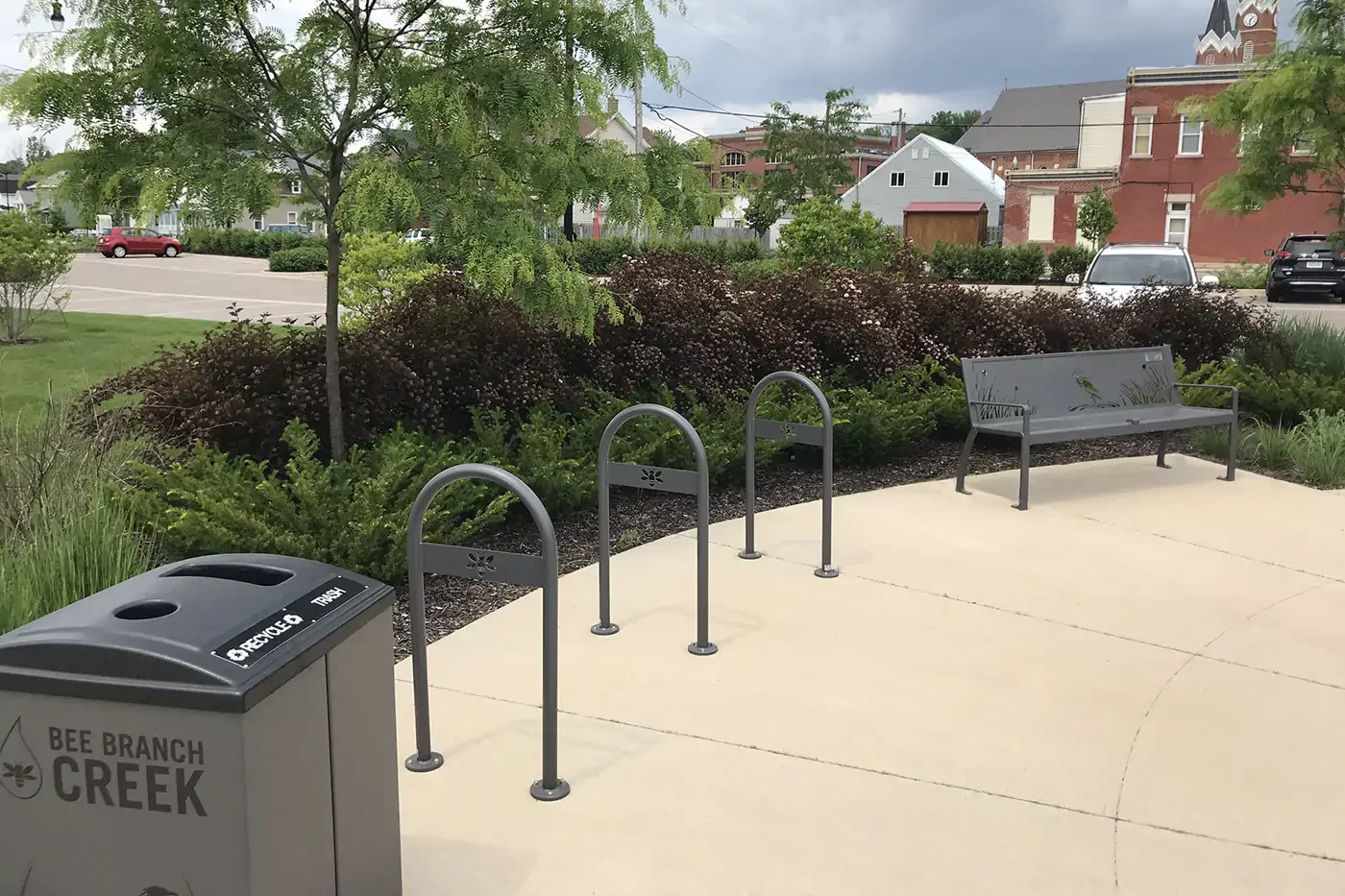 IA_Bee-Branch_Bench-bike-racks-trash Outdoor area with a public trash bin labeled
