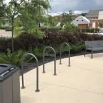Outdoor area with a public trash bin labeled 