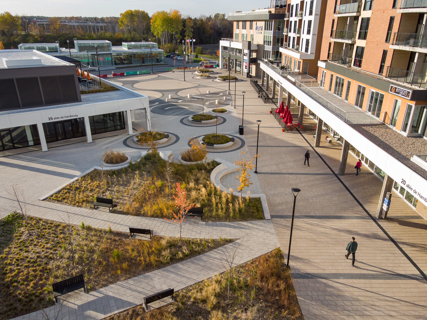 Over head view of the green space at AGORA Plaza in autumn. The image shows the pathways lined by comfortable Ogden benches.