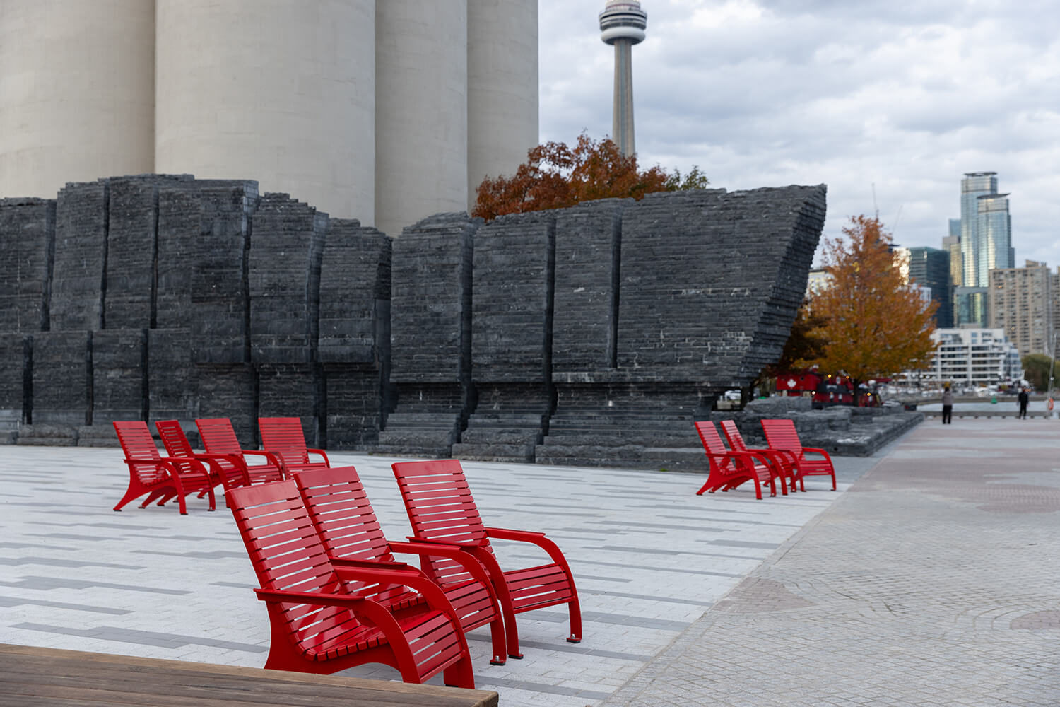 The CN Tower in Toronto overlooks Bathurst Quay Commons and red Maglin 720 Chairs