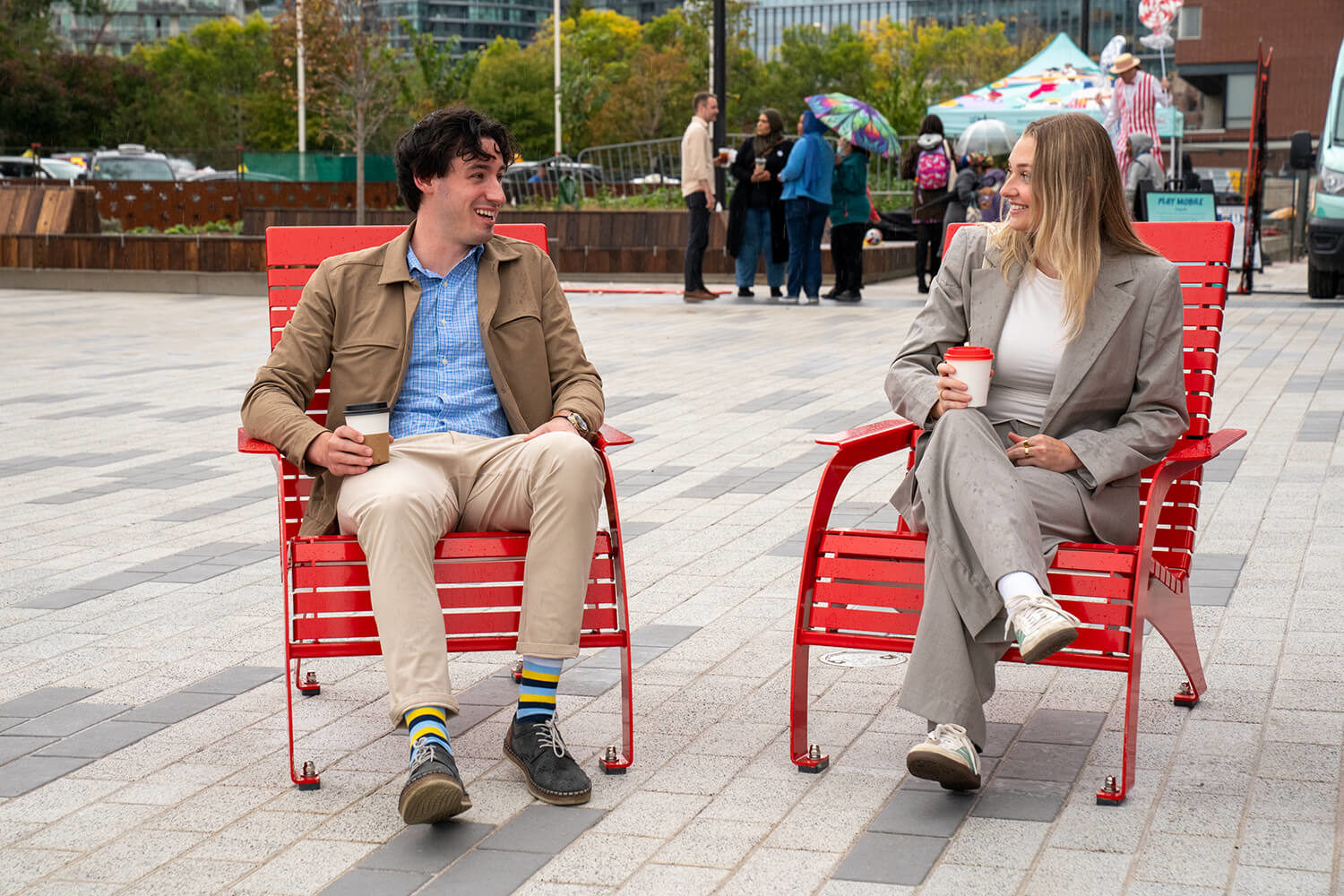 Couple sitting on Maglin's 720 Chairs on sunny day at Bathurst Quay Commons