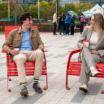 Couple sitting on Maglin's 720 Chairs on sunny day at Bathurst Quay Commons