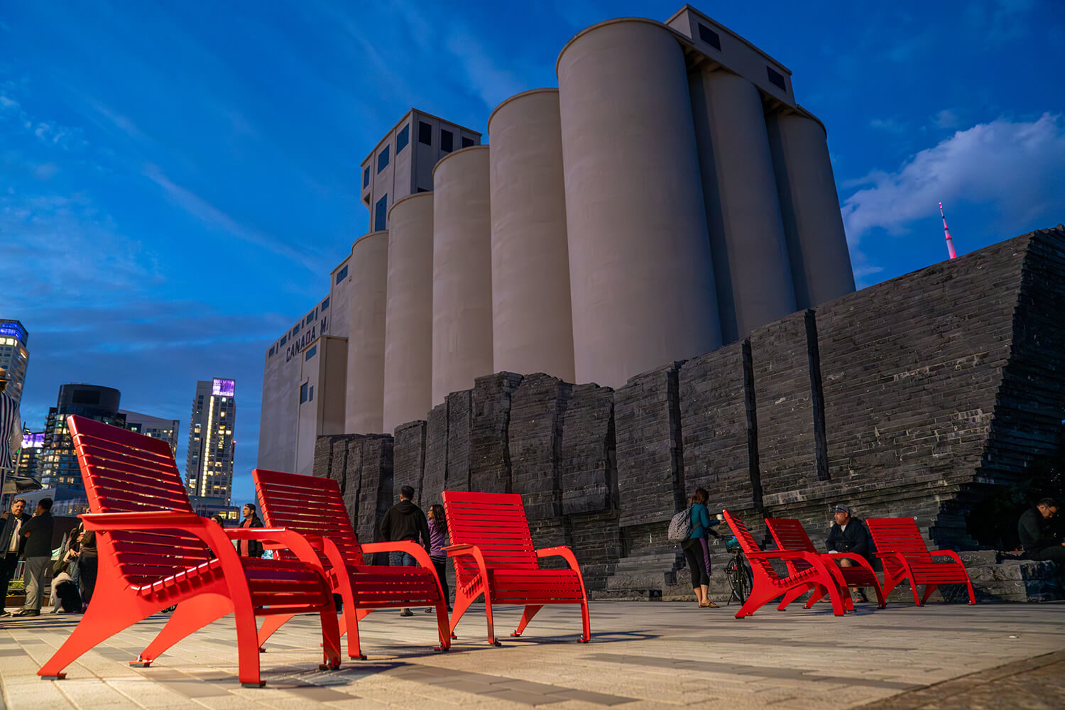 Maglin 720 Chairs brightly lit up against beautiful dark blue sky and silos at Bathurst Quay Commons